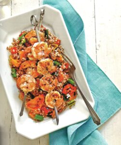 A plate of Grain Salad with Grilled Shrimp.