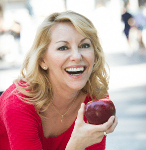 Chef Michael-Ann Rowe smiling and holding an apple.