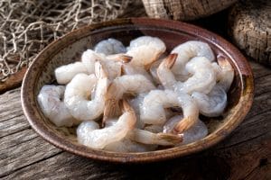 A bowl of peeled and deveined wild-caught American shrimp.