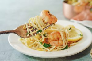 A fork twirled with shrimp scampi and pasta.