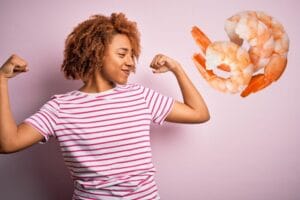 A woman flexing her muscles alongside shrimp.