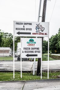 Ocean Select Seafood signage that reads "Frozen Shipping & Receiving Office."
