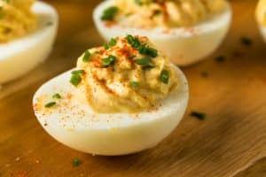 A wooden tray of Shrimp Deviled Eggs.